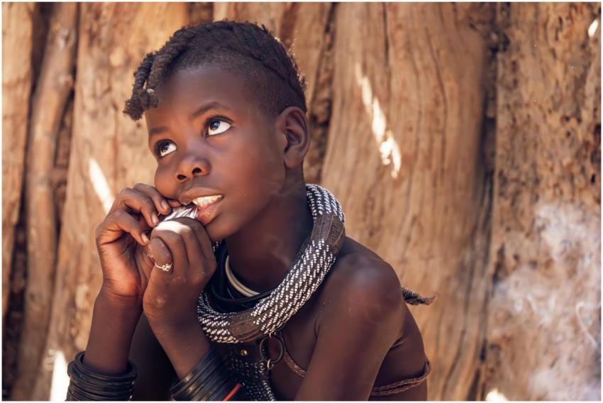 A thoughtful child with traditional attire reflect