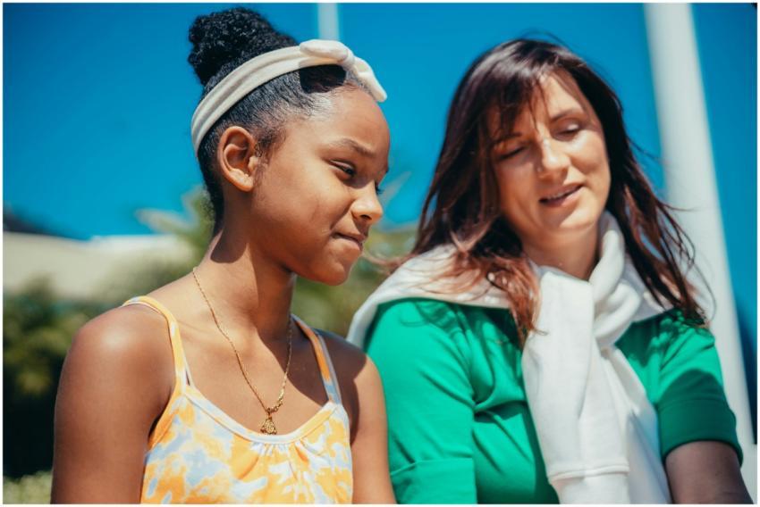 A mother and daughter enjoying a sunny day outdoor