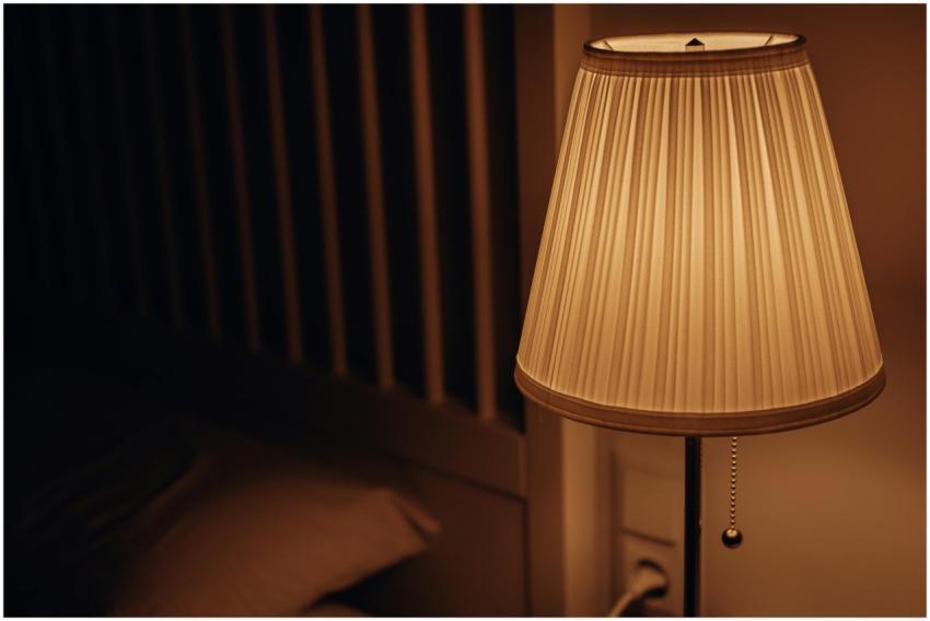 A dimly lit bedside lamp creating a warm and cozy