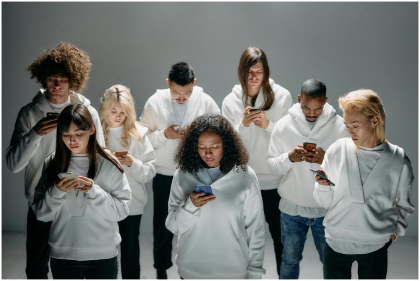 A diverse group of people in white hoodies engaged