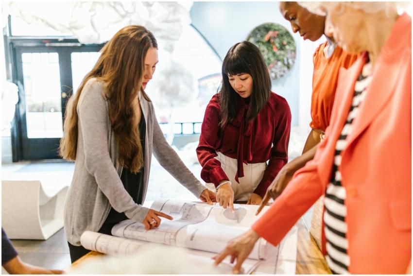 A diverse group of women in an office discussing p