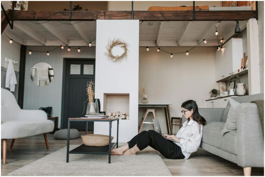 Cozy loft apartment with a woman working on a lapt