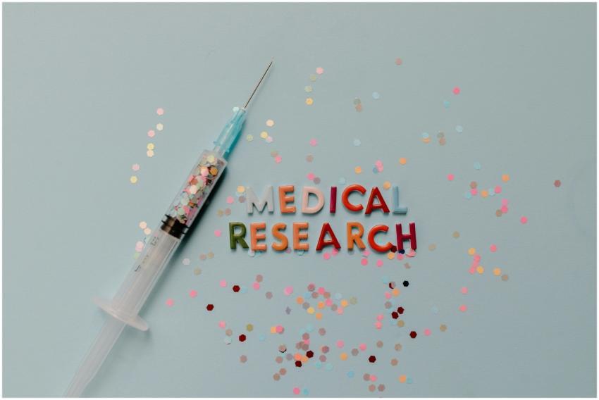 Close-up of a syringe with colorful confetti on me