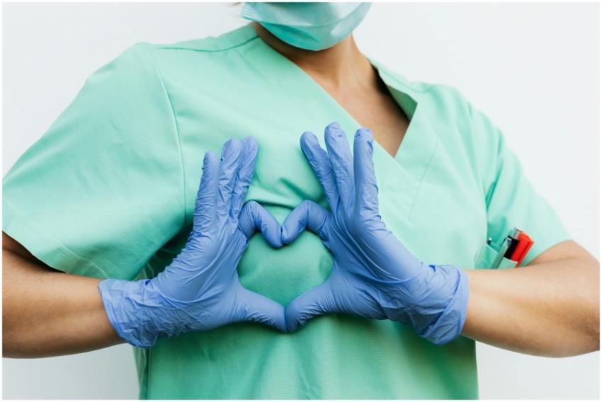 Medical professional forming a heart shape with bl