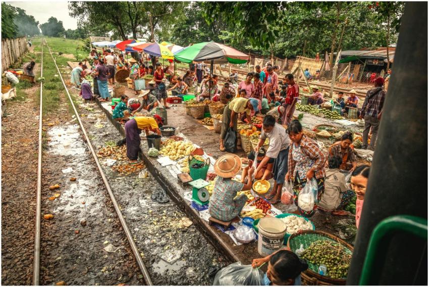 Bustling street market by railway in Yangon, Myanm