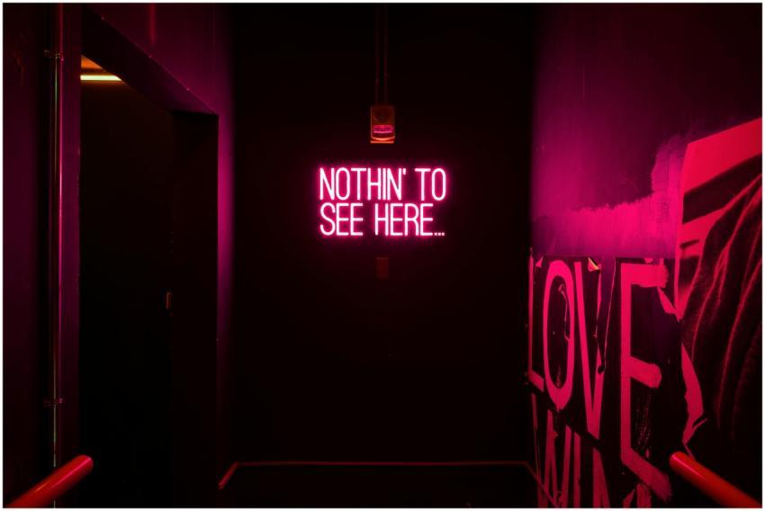 Neon sign reading 'Nothin' to see here...' in an a
