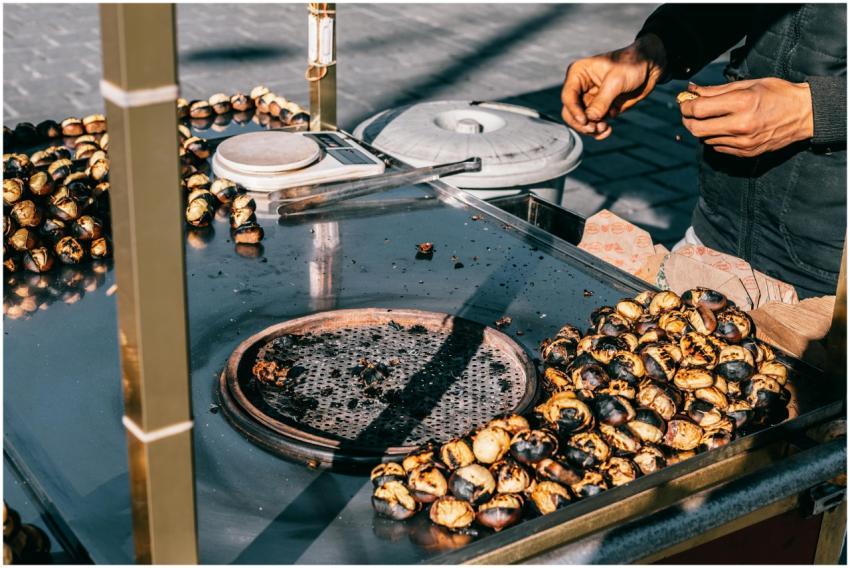 Street vendor preparing roasted chestnuts outdoors