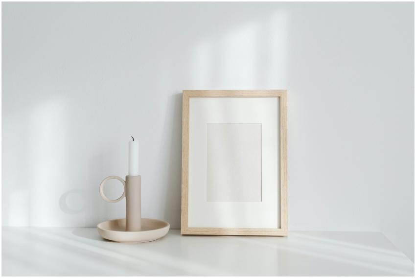 Elegant minimalist setup with candle and picture f