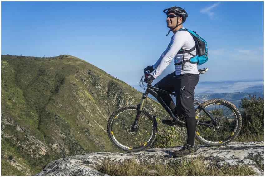 Adult cyclist on mountain bike overlooking scenic