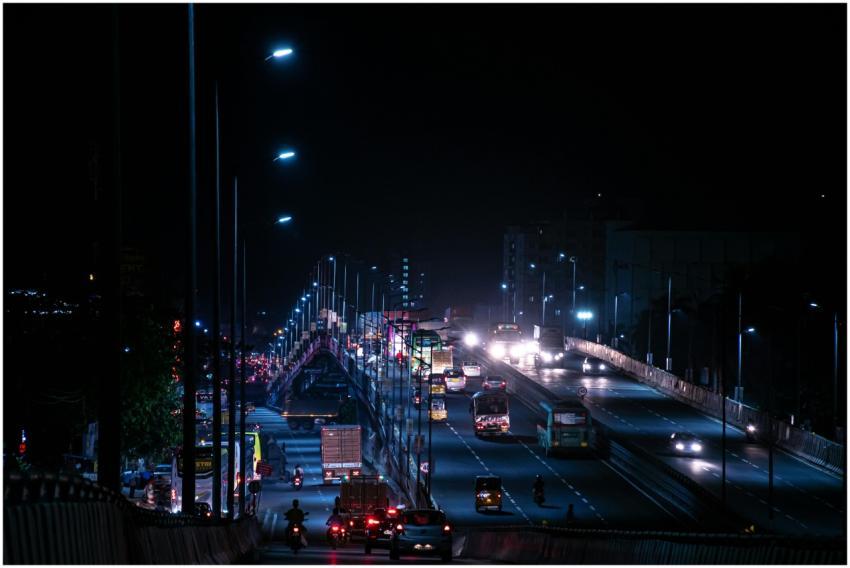 Dramatic night view of a busy highway bridge with