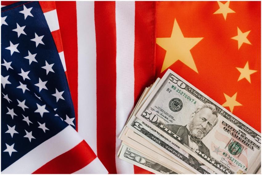 Close-up of US and China flags with US dollar bill
