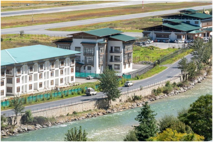 Scenic view of Bhutanese architecture along a rive