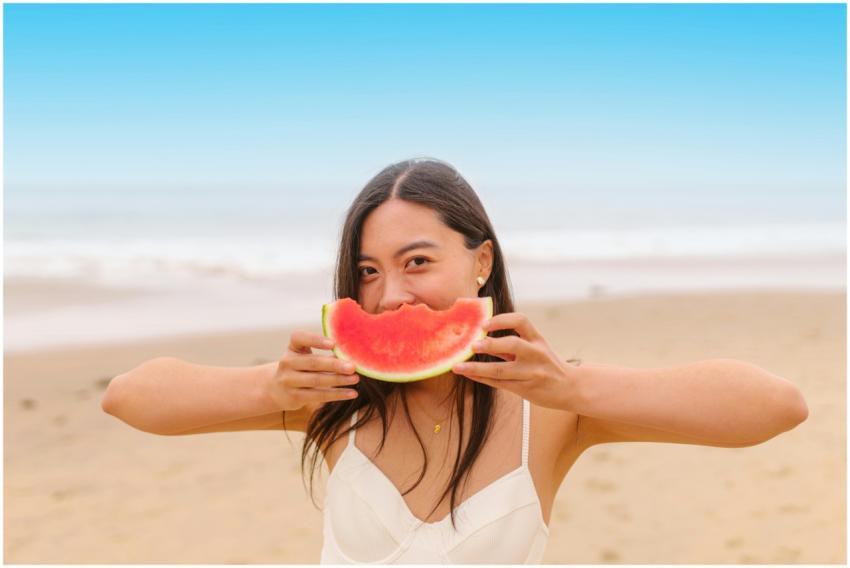 Young Asian woman enjoys a slice of watermelon on