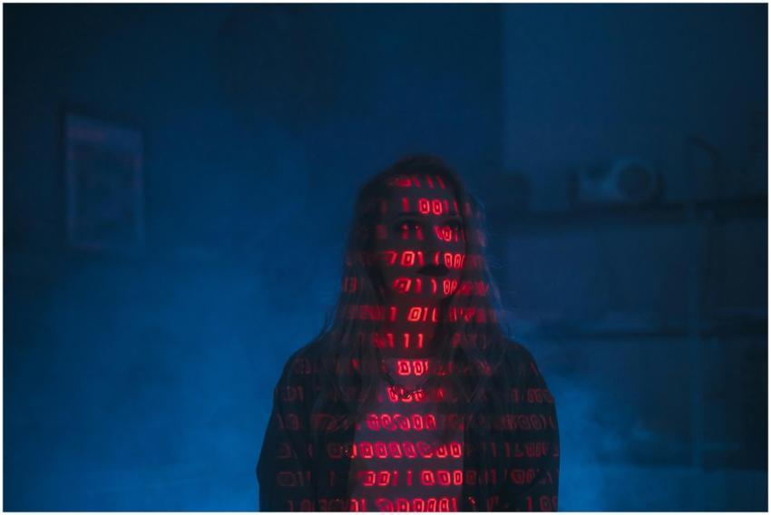 A mysterious silhouette with red binary code proje