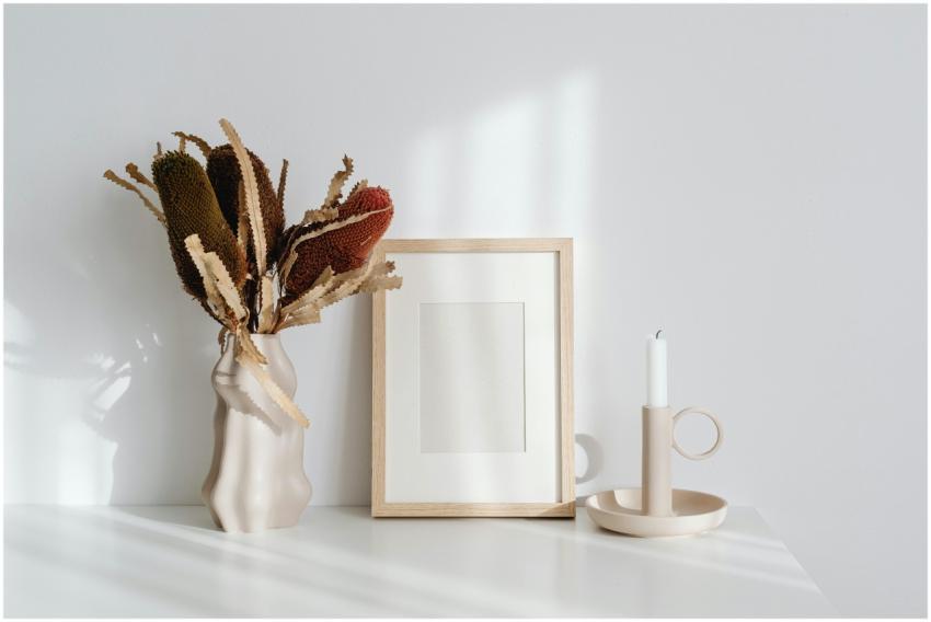 Elegant minimalist decor featuring a candle, frame