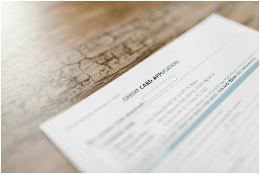 A credit card application on a wooden desk, depict