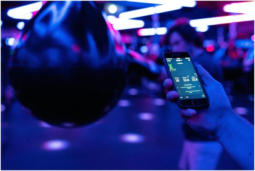 Smartphone displaying fitness tracking data next t