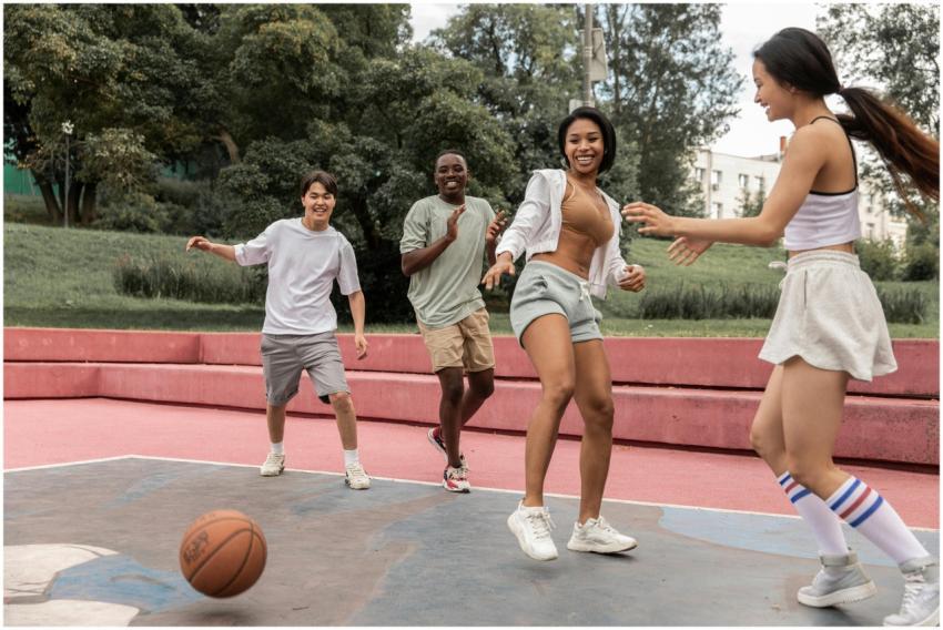 A group of diverse young adults playing basketball