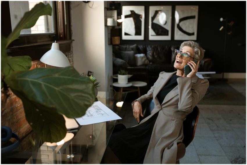 Senior woman in a modern office setting, smiling w