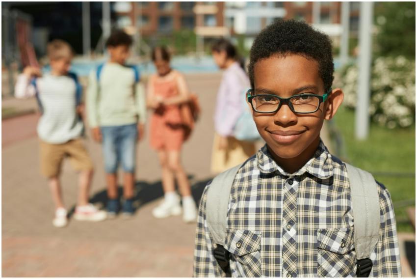 Diverse group of children smiling at school playgr