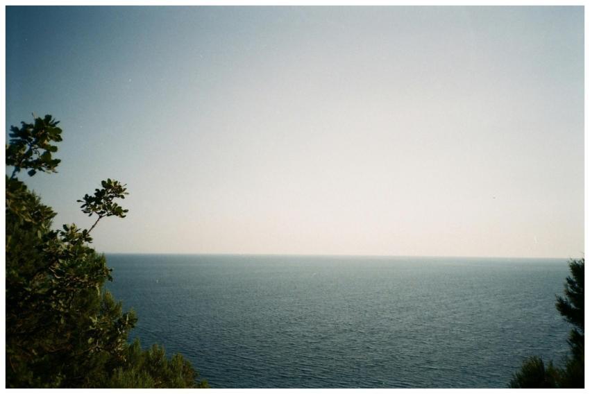 A tranquil seascape featuring a vast ocean and cle