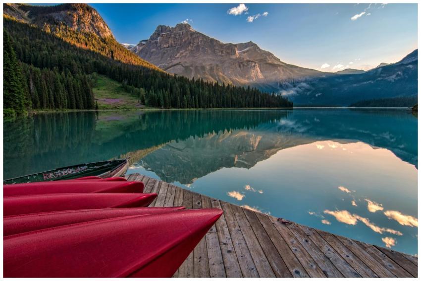Vibrant red canoes on Emerald Lake with stunning m