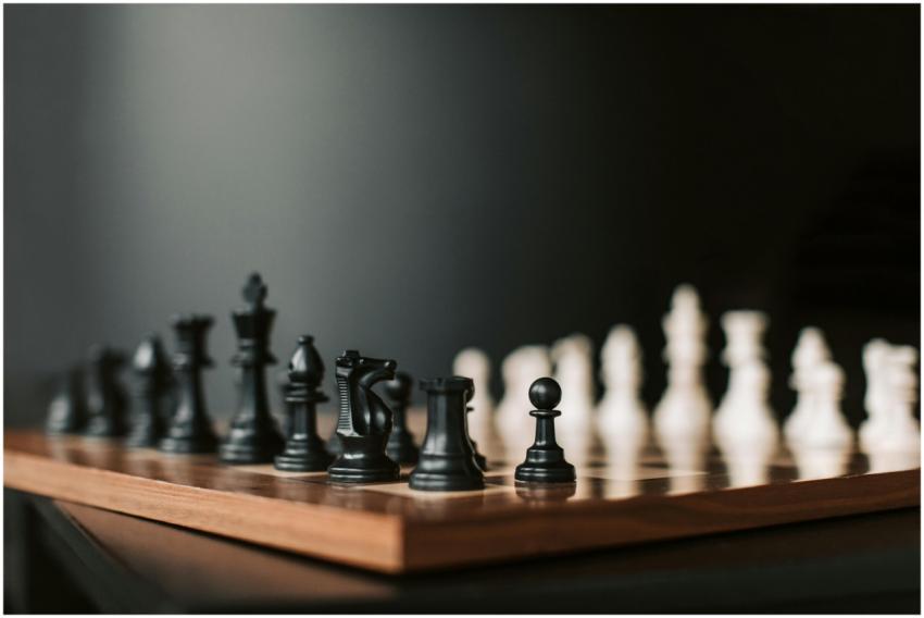 Close-up of a chessboard with black pieces ready t