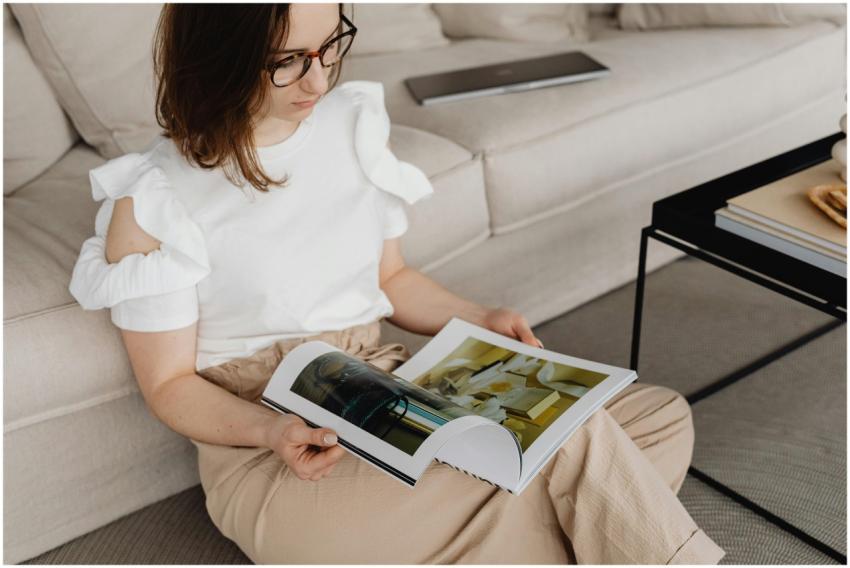 Woman in comfortable living room reading a magazin