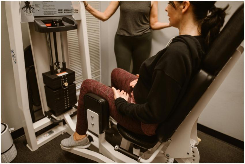 A woman performs exercises on a hip abductor machi