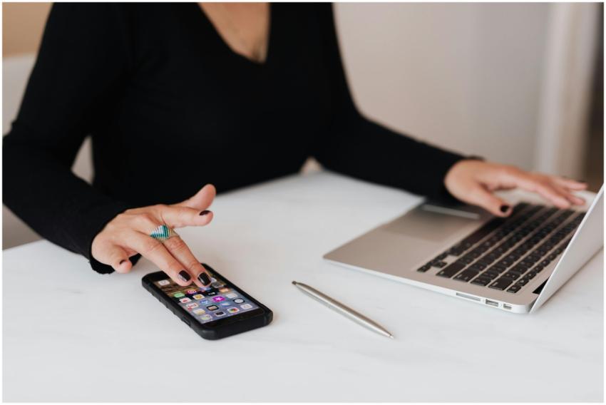 A professional woman multitasking with a smartphon