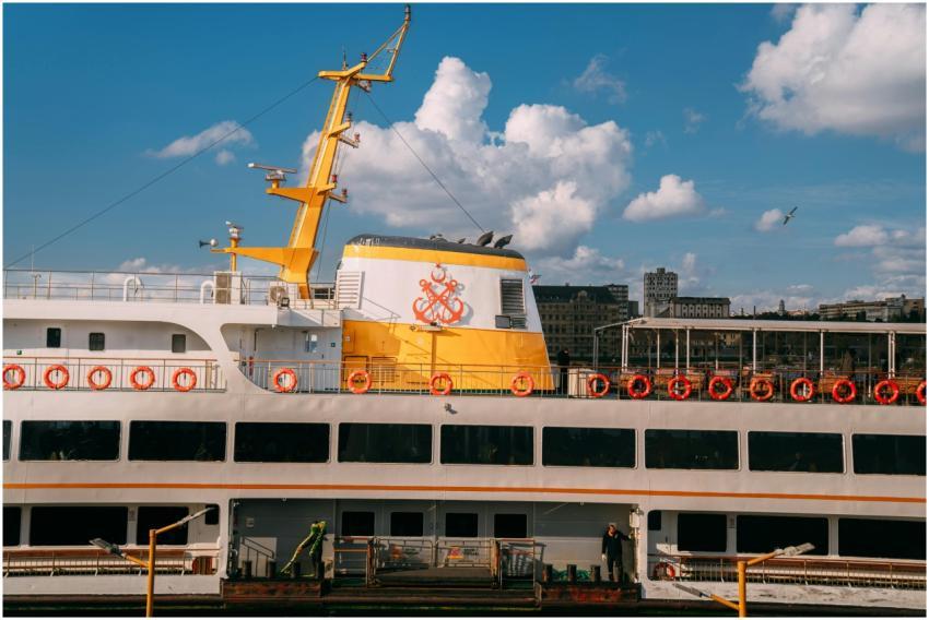 Bright ferry docked against a city backdrop, vibra