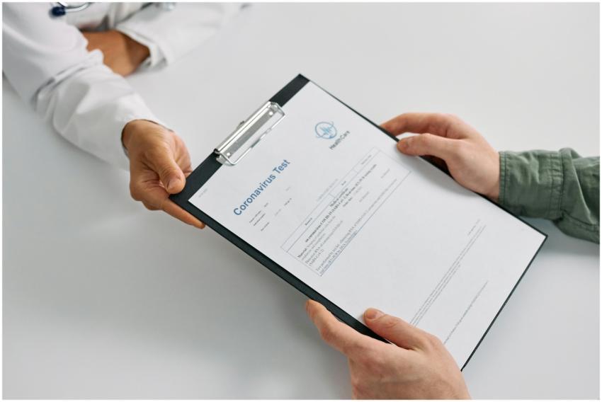 A doctor hands over coronavirus test results to a