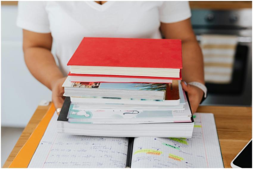 Close-up of a person holding a stack of colorful b