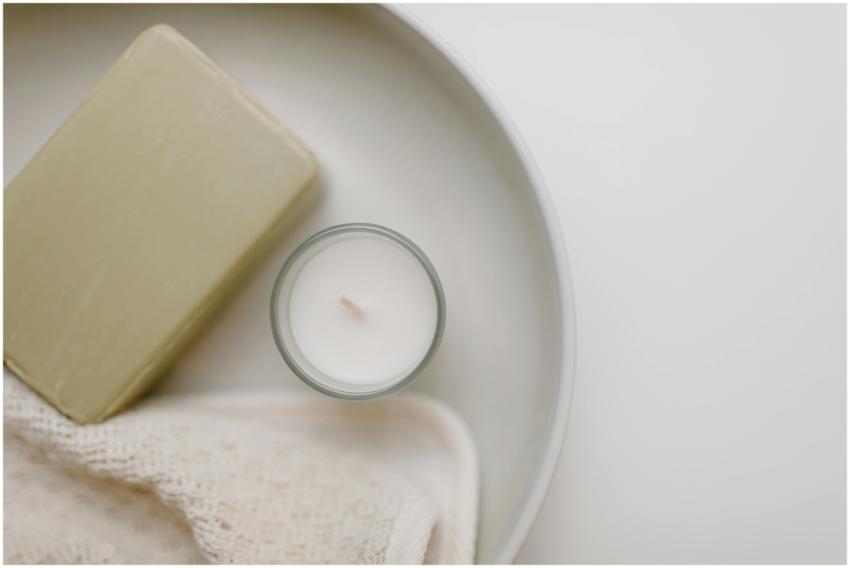 Serene close-up of a soap bar and candle on a clea