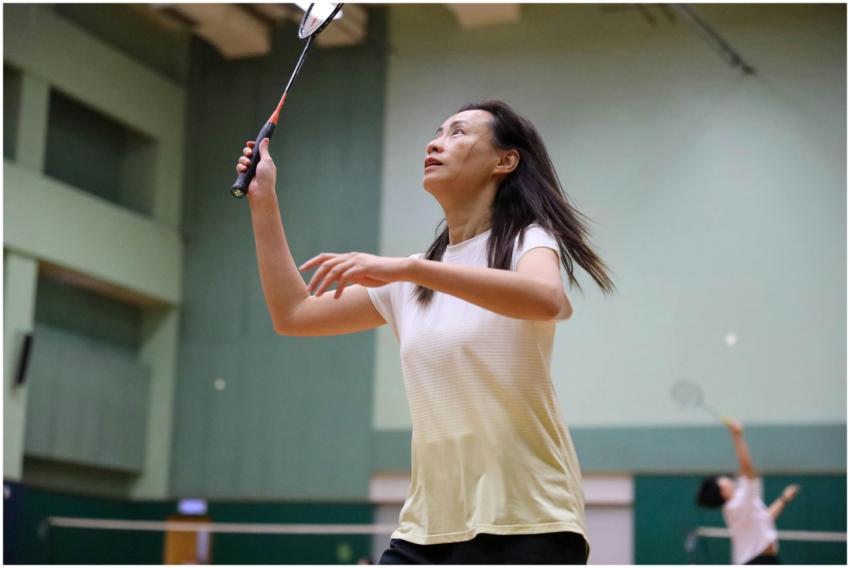 A woman in sportswear concentrating on her badmint