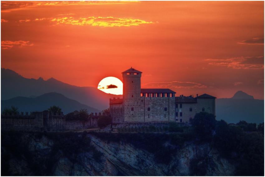Dramatic sunset behind a historic castle silhouett