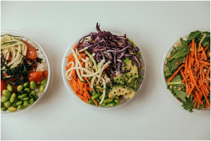 Top view of three healthy salad bowls featuring fr