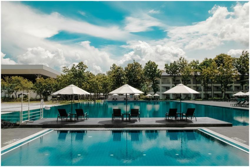 Explore a luxurious resort poolside with umbrellas