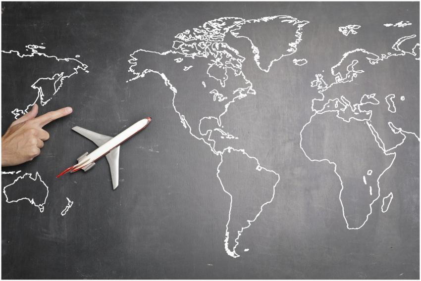 Top view of miniature airplane placed on over gray