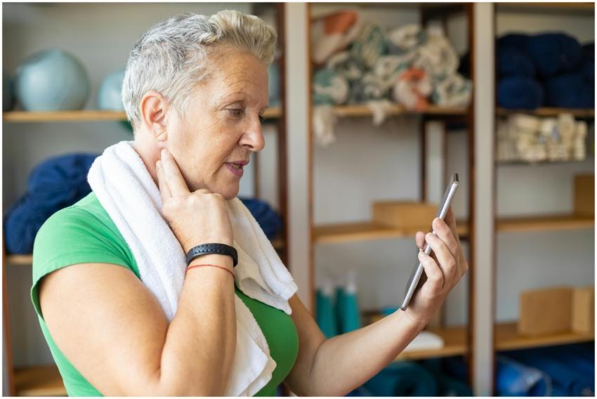 A senior woman using a smartphone to monitor her p