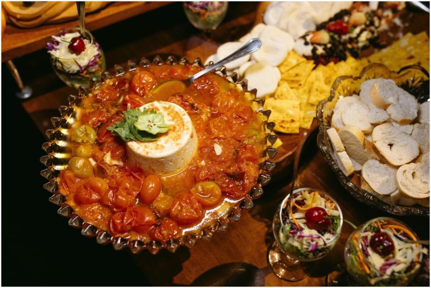 Savory gourmet cheese platter with fresh cherry to