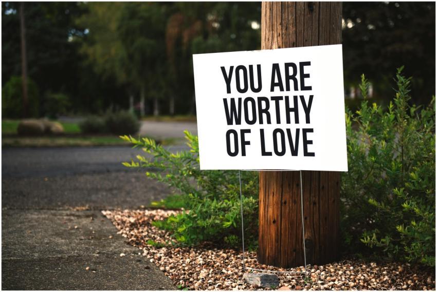 A positive message sign "You are worthy of love" i