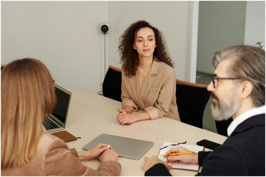 Three colleagues discussing ideas around a table i