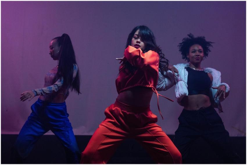 Dynamic trio of female dancers in a powerful hip h