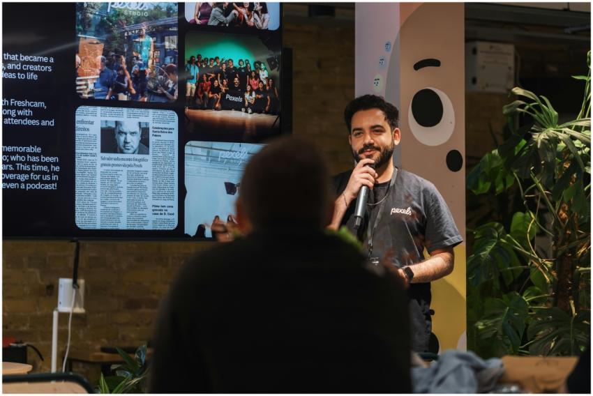 A speaker holding a microphone addresses an audien