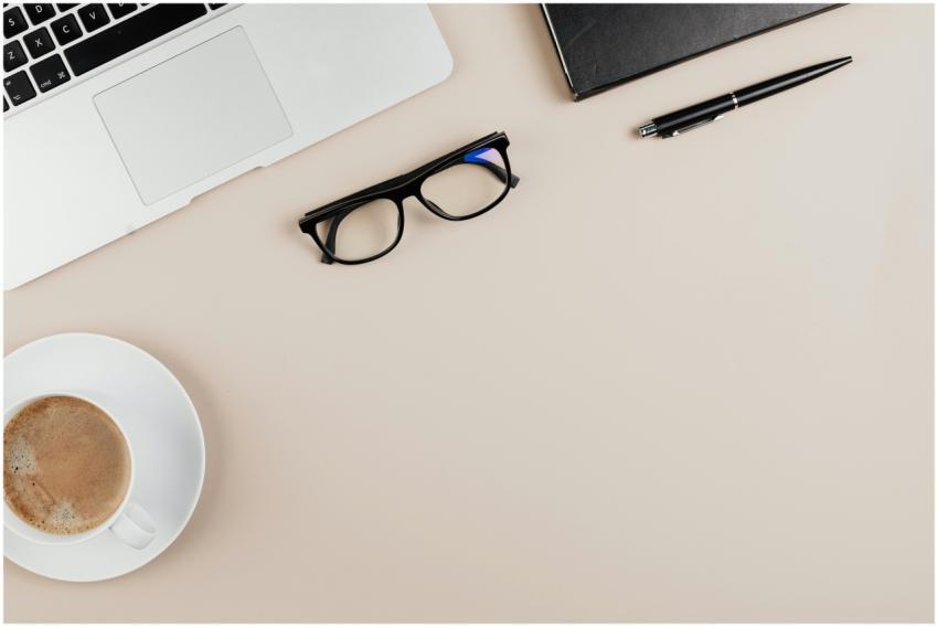 Minimalist workspace setup with laptop, coffee, an