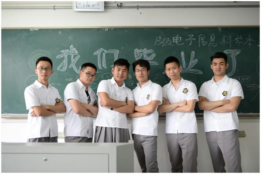 Group of male students standing confidently in cla