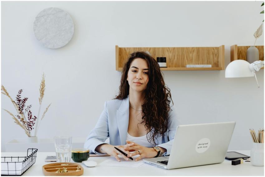 Businesswoman in a light blazer sitting at a desk