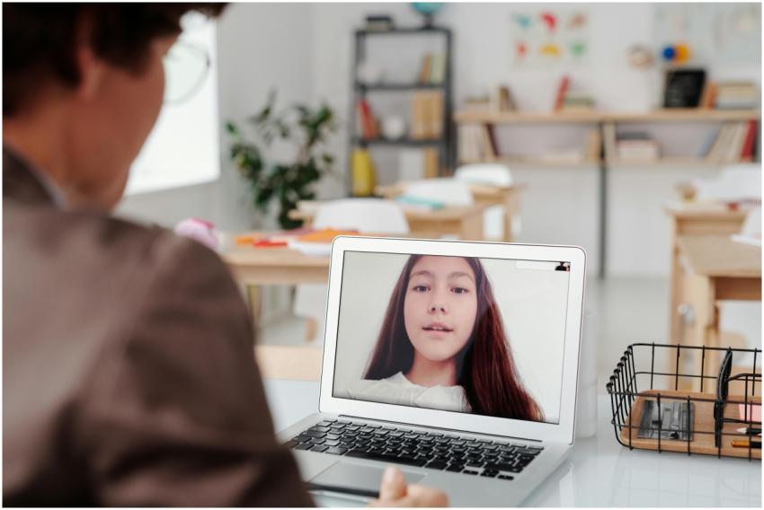 Teacher using laptop for virtual lesson with femal