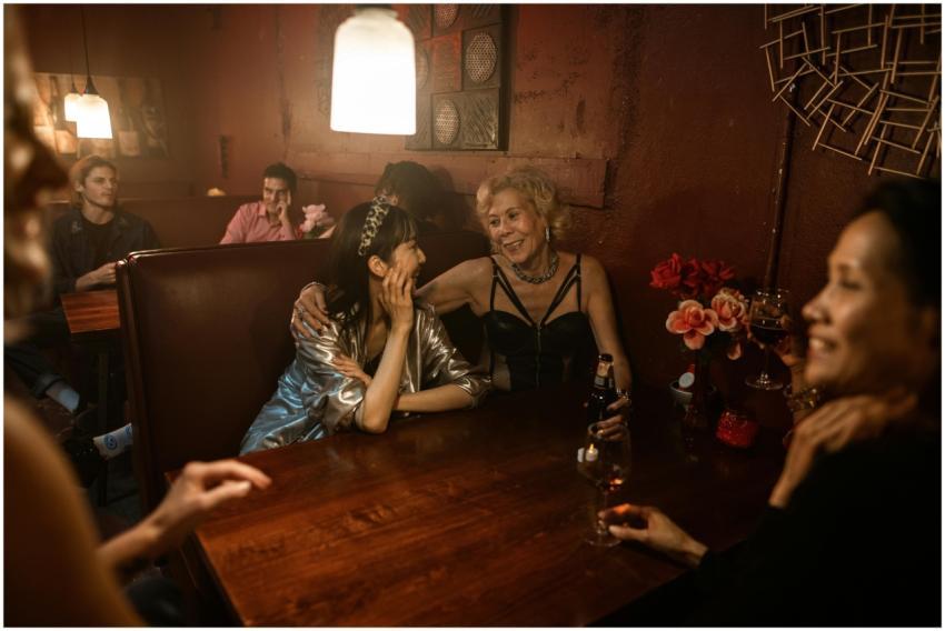 A lively group of friends enjoying drinks and laug